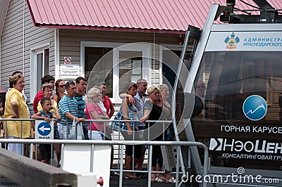 The queue of tourists landing in the lift cable car Mountain Carousel Sochi Editorial Stock Photo