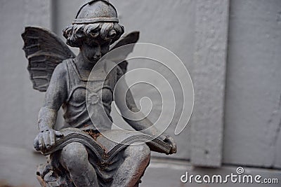 Reading angel in tone on tone contemplative study Stock Photo