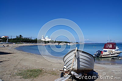 Quiet beach on the island of Agistri, Greece. Small pleasure boats moored in the beautiful bay. Stock Photo