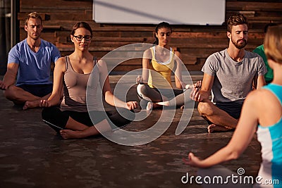 Quiet the mind and the soul will speak. a yoga instructor instructing her class. Stock Photo