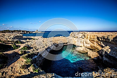 A quiet morning at the Grotta della Poesia in the Puglia region of southern Italy with crystal clear blue water Stock Photo