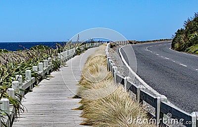 Quiet and peaceful coast road and wooden boardwalk near Wellington, New Zealand Stock Photo