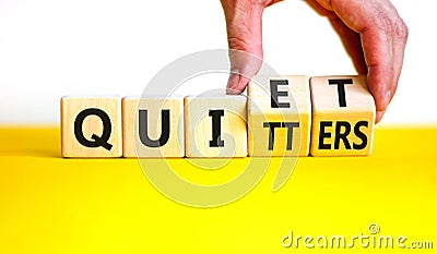 Quiet quitters symbol. Concept words Quiet quitters on wooden cubes. Businessman hand. Beautiful yellow table white background. Stock Photo