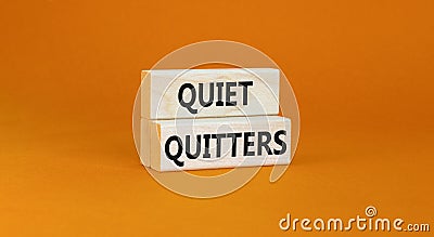 Quiet quitters symbol. Concept words Quiet quitters on wooden blocks. Beautiful orange table orange background. Business and quiet Stock Photo
