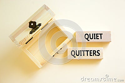 Quiet quitters symbol. Concept words Quiet quitters on wooden blocks. Beautiful white table white background. Empty wooden chest. Stock Photo