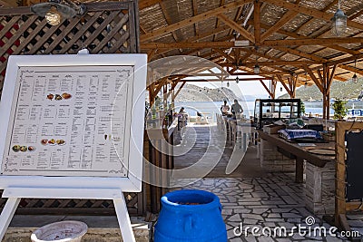 A Quiet Restaurant by Pedi Harbor in Symi Greece Editorial Stock Photo