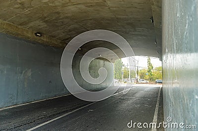 a quiet underpass tunnel road with no vehicles passing by during the day Stock Photo