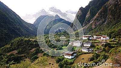 A quiet village under snow mountain Stock Photo