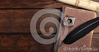 Quill, inkwell, old book and parchment scroll on wooden table, flat lay with space for text. Banner design Stock Photo