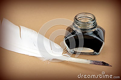 Quill pen and glass ink bottle Stock Photo