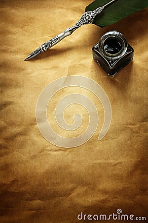 Quill pen and ink well on parchment paper Stock Photo