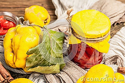 Quince jam or confiture brewed with brown sugar. Ripe whole fruits, sweet dessert, fragrant spices Stock Photo