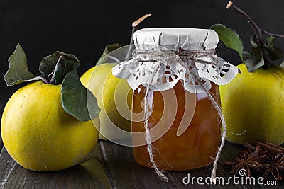 Quince jam in glass jar and fresh quince Stock Photo