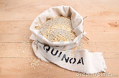 Quinoa flakes in a cream fabric bag with stencilled label Stock Photo