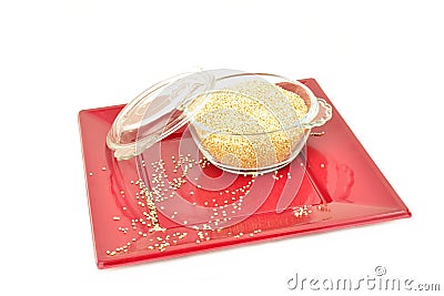 Quinoa in glass bowl on a red plate isolated Stock Photo