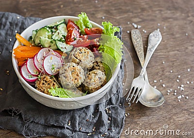 Quinoa meatballs and vegetable salad. Buddha bowl on a wooden table, top view. Healthy, diet, vegetarian food concept. Stock Photo