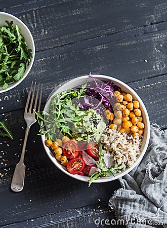 Quinoa and spicy chickpea vegetable vegetarian buddha bowl. Healthy food concept. On a dark background Stock Photo