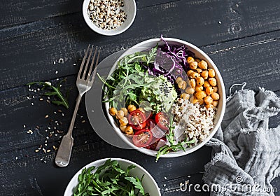 Quinoa and spicy chickpea vegetable vegetarian buddha bowl. Healthy food concept. On a dark background Stock Photo