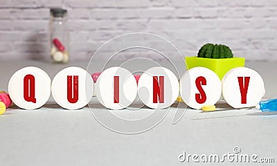 quinsy, text on wood block, blue background Stock Photo