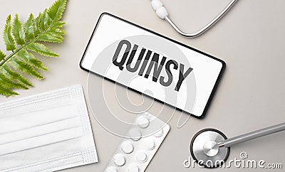 quinsy word on smartphone,stethoscope and green plant Stock Photo