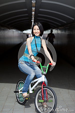 Quirky, funky chinese woman on street bike Stock Photo