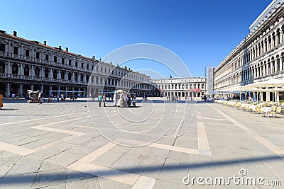 Quite empty Saint Mark`s Square Piazza San Marco and arcade of procuracies Procuratie Vecchie in Venice, Italy Editorial Stock Photo