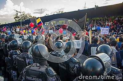 Quito, Ecuador - April 7, 2016: Police awaiting overlooking peaceful anti government protests in Shyris Avenue Editorial Stock Photo