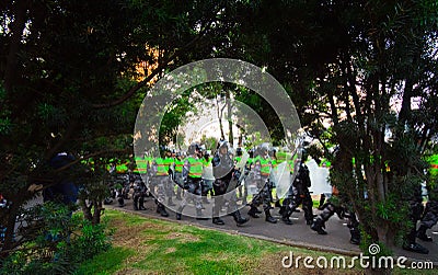 Quito, Ecuador - April 7, 2016: Police awaiting overlooking peaceful anti tax march in Shyris Avenue, beautiful blue sky Editorial Stock Photo