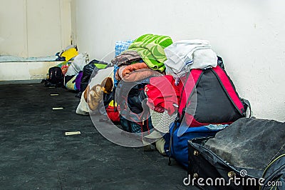 QUITO, ECUADOR, AUGUST 21, 2018: Pile of colorful clothes, bags and accessories in the ground of a room inside of a Editorial Stock Photo