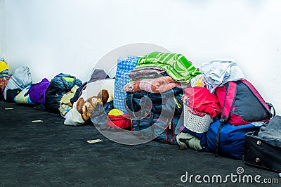 QUITO, ECUADOR, AUGUST 21, 2018: Pile of colorful clothes, bags and accessories in the ground of a room inside of a Editorial Stock Photo