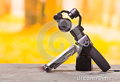 QUITO, ECUADOR- DECEMBER 22, 2017: Osmo Mobile gimbal, new generation of electronic stabilizer over a wooden table in a Editorial Stock Photo