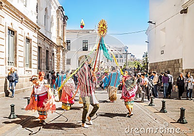 Quito, Ecuador - January 11, 2018: Outdoor view of unidentified people wearing beautiful dresses and straw hats, dancing Editorial Stock Photo