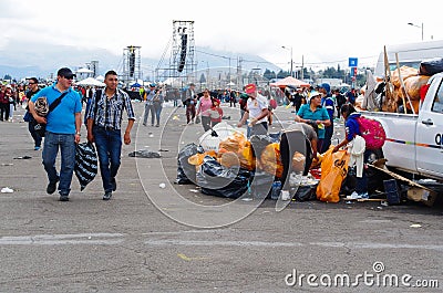 QUITO, ECUADOR - JULY 7, 2015: After pope Francisco mass, people picking up the garbage and colecting in bags Editorial Stock Photo