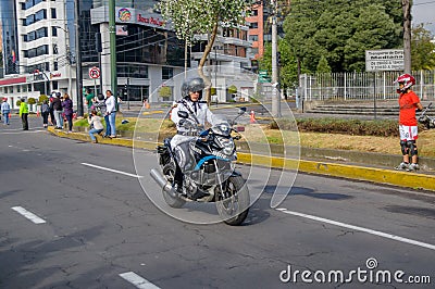 QUITO, ECUADOR - JULY 7, 2015: Traffic police with white uniform rolling in the city, guard of the pope Editorial Stock Photo