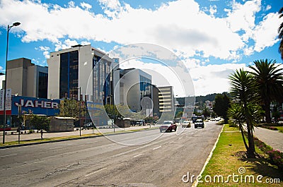 QUITO, ECUADOR - MAY 06 2016: Unidentified people waling in the mainstreet in NNUU avenue with some buildings, cars and Editorial Stock Photo