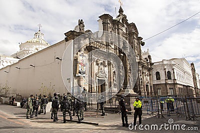 Heavily armed policemen and women guarding the 1766 baroque Jesuit church La Compania Editorial Stock Photo