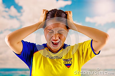 QUITO, ECUADOR -8 OCTOBER, 2016: Young ecuadorian woman wearing official Marathon football shirt standing facing camera Editorial Stock Photo