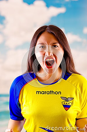 QUITO, ECUADOR -8 OCTOBER, 2016: Young ecuadorian woman wearing official Marathon football shirt standing facing camera Editorial Stock Photo