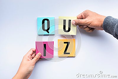 Quiz word on notepaper with hand Stock Photo