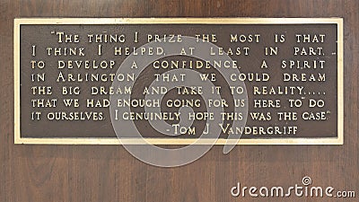 Quote on the base of a bronze statue of legendary mayor Tom Vandergriff inside City Hall in downtown Arlington, Texas. Editorial Stock Photo