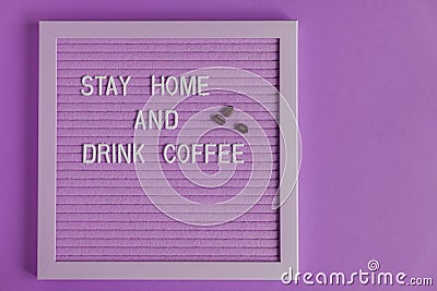 Quote stay home and drink coffee on purple decorative board. decoratin with coffee beans. Typography board for interior decoration Stock Photo