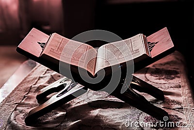 Quran on a rihal or wooden book stand at home Stock Photo