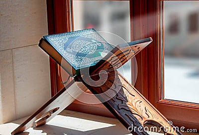 Quran, on wooden table in mosque Stock Photo