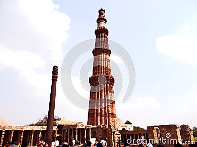 Qutub Minar & Iron Pillar in Qutub complex, one of Delhi`s most curious structures Editorial Stock Photo