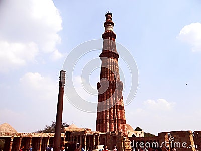 Qutub Minar & Iron Pillar in Qutub complex, one of Delhi`s most curious structures Editorial Stock Photo