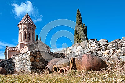 Qvevri, Georgian traditional jug for wine making near the stone wall Stock Photo