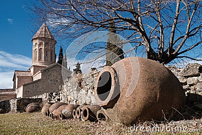 Qvevri, Georgian traditional jug for wine making near the stone wall Stock Photo