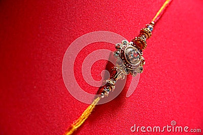 Raakhi on red background Stock Photo