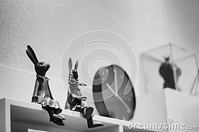 Rabbit miniature. Soft focus of bunny statuette display on the shelf in living room. Photo is processed in black and white. Copy Editorial Stock Photo