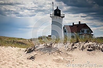 Race Point Lighthouse with Storm Clouds in Cape Cod Stock Photo